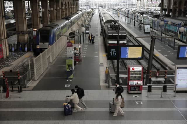 Travelers walk in the deserted Gare du Nord train station in Paris. Picture: AP Photo/Lewis Joly