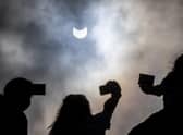 Partial solar eclipse watched by people through welders glass on Arthur's Seat in Edinburgh picture: Katielee Arrowsmith SWNS