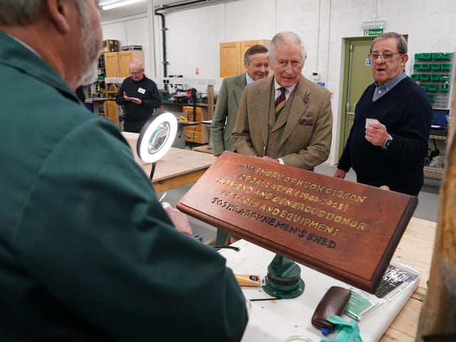King Charles learns about how the plaques were made.