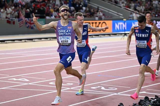 Britain's Josh Kerr celebrates as he crosses the line ahead of Norwegians Jakob Ingebrigtsen, right, and Narve Gilje Nordas to win the men's 1500m final at the World Athletics Championships in Budapest on August 23, 2023. (Photo by KIRILL KUDRYAVTSEV/AFP via Getty Images)