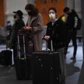 Travellers wait for trains on the concourse at King's Cross train station. Pic: Victoria Jone/PA Wire