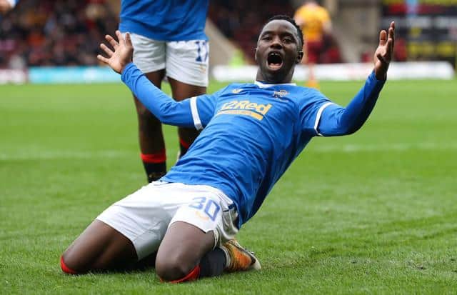 Rangers striker Fashion Sakala slides in celebration of the second of his three goals in the 6-1 win over Motherwell at Fir Park on Sunday. (Photo by Craig Williamson / SNS Group)