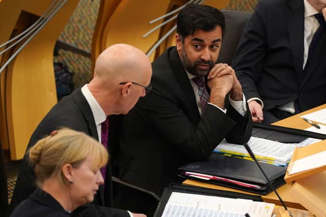 Health secretary Humza Yousaf speaks to Deputy First Minister John Swinney during First Minister's Questions. Picture: Andrew Milligan/PA Wire