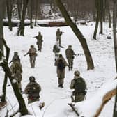 Members of Ukraine's Territorial Defense Forces, volunteer military units of the Armed Forces, train in a city park in Kyiv, Ukraine.  (AP Photo/Efrem Lukatsky)