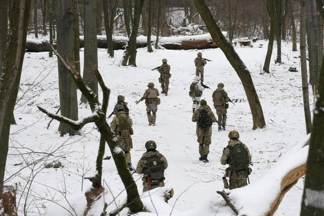 Members of Ukraine's Territorial Defense Forces, volunteer military units of the Armed Forces, train in a city park in Kyiv, Ukraine.  (AP Photo/Efrem Lukatsky)