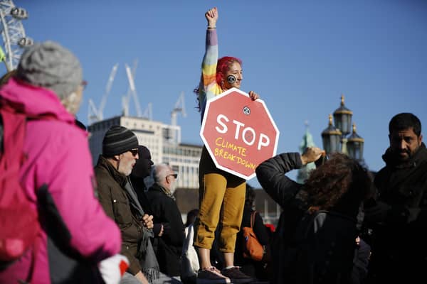 A climate change activist gets her message across during a protest in London