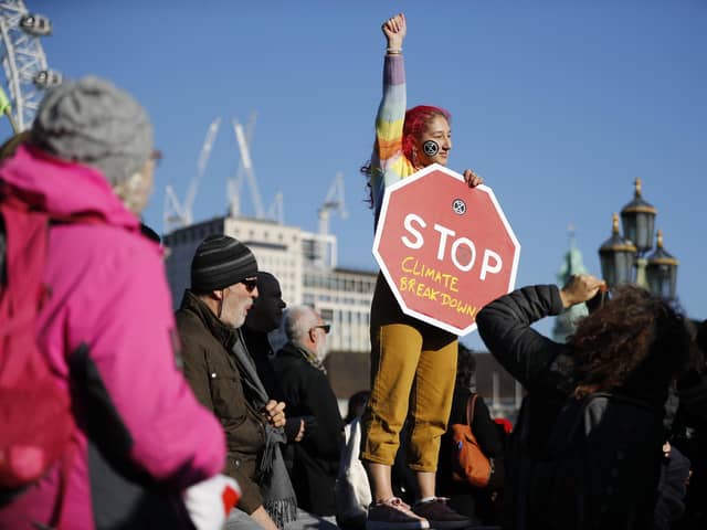 A climate change activist gets her message across during a protest in London