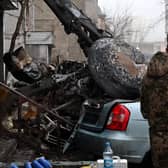 A military stands at the site where a helicopter crashed near a kindergarten outside the capital Kyiv, killing Sixteen people, including two children and Ukrainian interior minister, on January 18, 2023, amid the Russian invasion of Ukraine. (Photo by Sergei Supinsky / AFP) (Photo by SERGEI SUPINSKY/AFP via Getty Images)