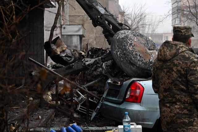 A military stands at the site where a helicopter crashed near a kindergarten outside the capital Kyiv, killing Sixteen people, including two children and Ukrainian interior minister, on January 18, 2023, amid the Russian invasion of Ukraine. (Photo by Sergei Supinsky / AFP) (Photo by SERGEI SUPINSKY/AFP via Getty Images)