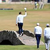 Tiger Woods acknowledges the Old Course crowd as he crosses the Swilcan Bridge during last year's Open (Picture: Ross Kinnaird/Getty Images)