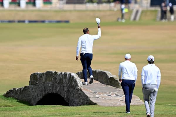 Tiger Woods acknowledges the Old Course crowd as he crosses the Swilcan Bridge during last year's Open (Picture: Ross Kinnaird/Getty Images)