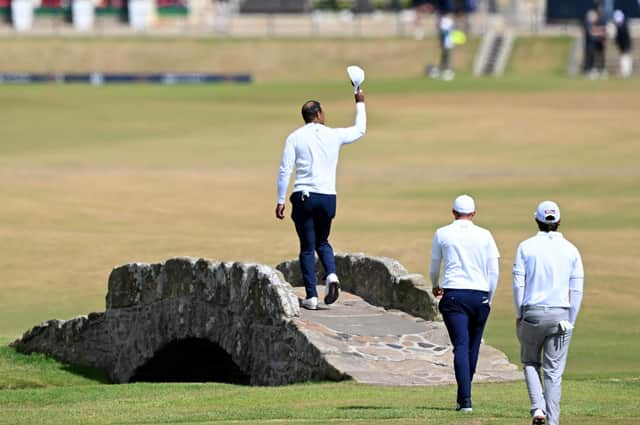 Tiger Woods acknowledges the Old Course crowd as he crosses the Swilcan Bridge during last year's Open (Picture: Ross Kinnaird/Getty Images)