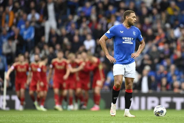 Rangers striker Cyriel Dessers cuts a forlorn figure as Aberdeen players celebrate taking the lead at Ibrox. (Photo by Rob Casey / SNS Group)