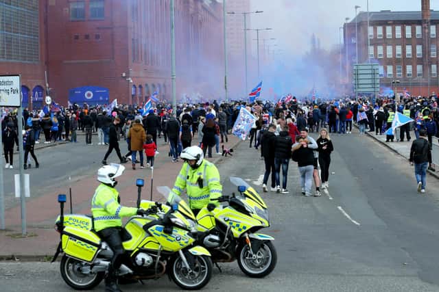 Police park up outside of the Ibrox Stadium as fans gather to celebrate Rangers winning the Scottish Premiership title on March 7.