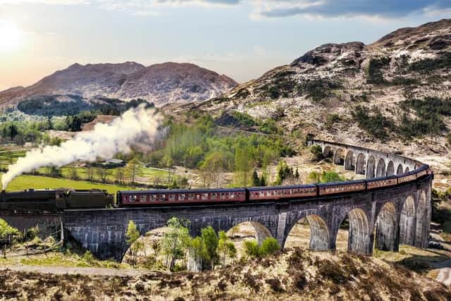 The Jacobite steam train travelling across the Glenfinnan Viaduct.