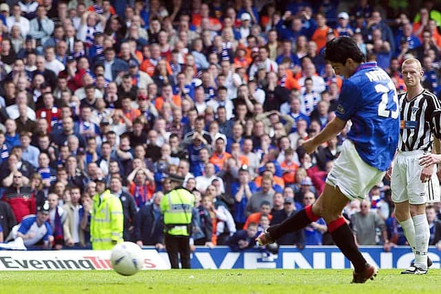 Midfielder Mikel Arteta converts an injury time penalty to complete a 6-1 win over Dunfermline, securing the championship for Rangers in 2003.