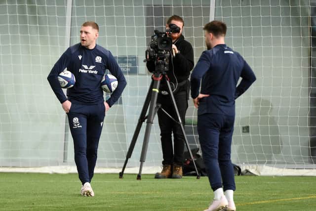 Scotland halfbacks Finn Russell and Ali Price train during the Six Nations as a Netflix cameraman films the session. (Photo by David Gibson/Fotosport/Shutterstock)