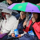 Tennis fans console themselves with crisps on a rainy day at Wimbledon (Picture: Mike Egerton/PA)