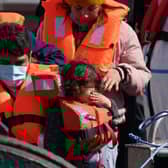 A group of people, including a child, thought to be migrants are brought in to Dover, Kent, following a small boat incident in the Channel earlier this month.  Photo: Gareth Fuller/PA Wire