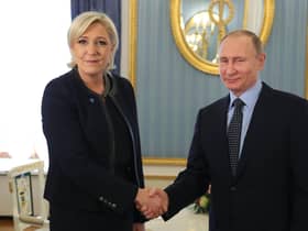 Marine Le Pen shakes hands with Vladimir Putin in 2017, three years after his forces annexed Crimea from Ukraine (Picture: Mikhail Klimentyev/AFP via Getty Images)