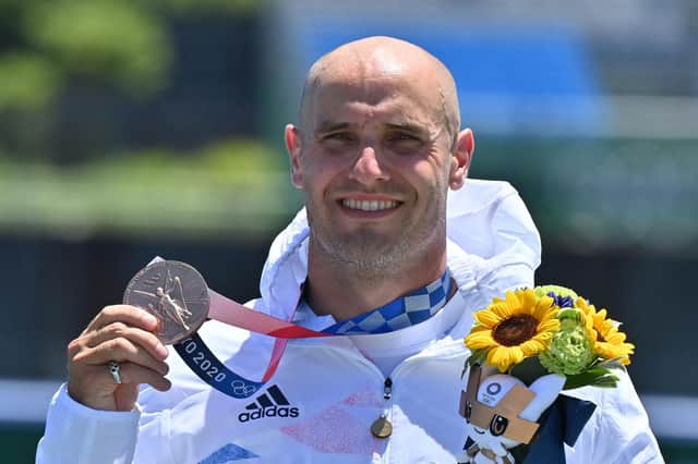 Bronze medallist Liam Heath poses on the podium following the men's kayak single 200m final