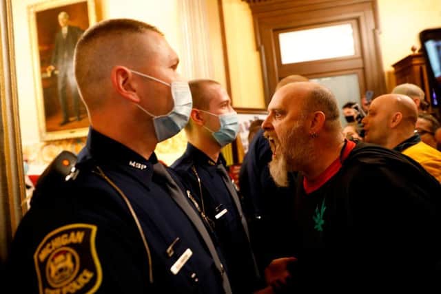 Protestors tried to enter the Michigan House of Representative chamber in April 30, upset with Whitmer's mandatory closure to curtail Covid-19 (Photo: JEFF KOWALSKY/AFP via Getty Images)