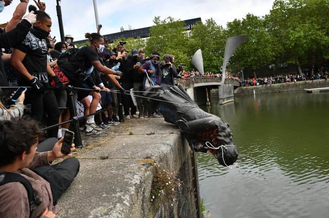 In June 2020, protesters throwing the statue of Edward Colston into Bristol harbour during a Black Lives Matter protest rally.