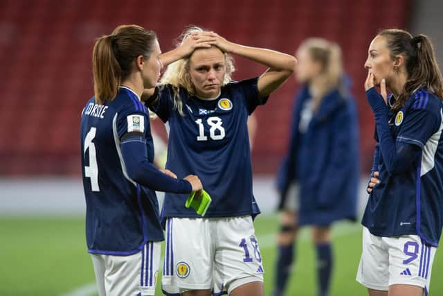 Scotland's Rachel Corsie attemps to console a crestfallen Claire Emslie and Caroline Weir at full time. (Photo by Mark Scates / SNS Group)