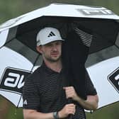 Connor Syme shelters under his umbrella during the final round of the SDC Championship at St. Francis Links in South Africa. Picture: Stuart Franklin/Getty Images.