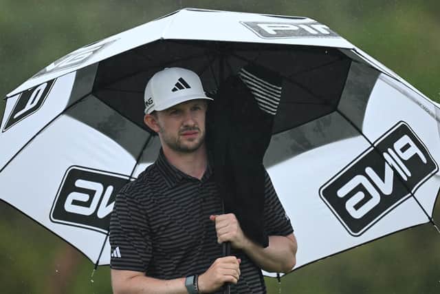 Connor Syme shelters under his umbrella during the final round of the SDC Championship at St. Francis Links in South Africa. Picture: Stuart Franklin/Getty Images.