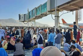 Afghans crowd the tarmac of Kabul airport on 16 August, 2021, trying to flee the country after the Taliban took control PIC: AFP via Getty Images