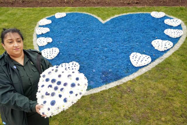 Reena Farrington, call supervisor West Midlands Ambulance Service NHS Trust, lays a wreath during a pandemic anniversary remembrance event and minute's silence at National Memorial Arboretum at Alrewas in Staffordshire on Friday March 11, 2022. Picture: PA Wire