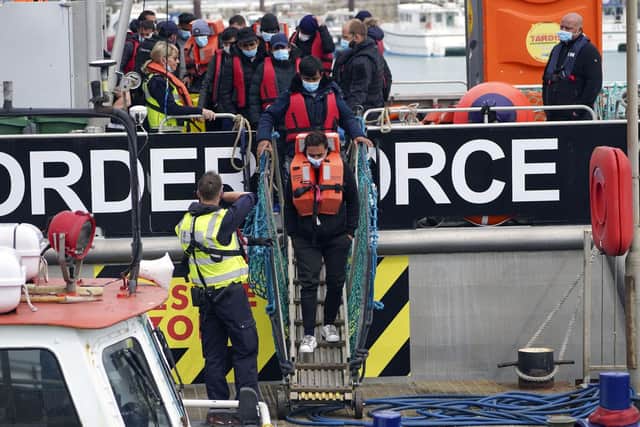 A group of people thought to be migrants are brought in to Dover, Kent, following a small boat incident in the Channel yesterday