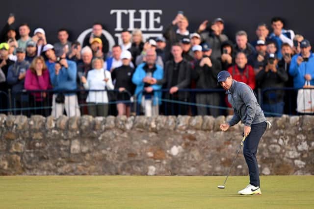 Rory McIlroy celebrates holing a birdie putt on the 17th hole at St Andrews. Picture: Ross Kinnaird/Getty Images.