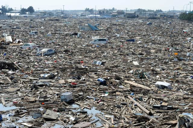 Debris lies strewn across a large area of land after the tsunami hit Natori City, Miyagi prefecture, in 2011 (Picture: Mike Clarke/AFP via Getty Images)