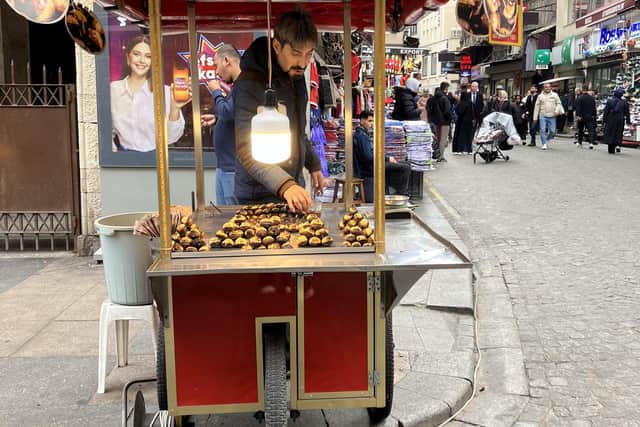 A street vendor sells roasted chestnuts. Pic: J christie