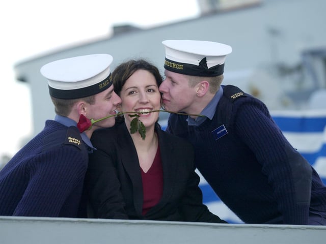 Sailors Mark Horburgh and Scott Milligan give Lynsey Patterson a kiss as HMS Edinburgh visits her adopted city on Valentine's Day 2002.
