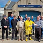 The cheque for £150 being presented to Fraserburgh RNLI