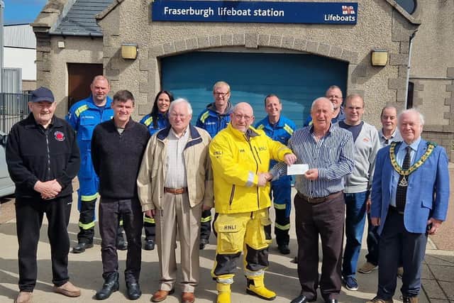 The cheque for £150 being presented to Fraserburgh RNLI