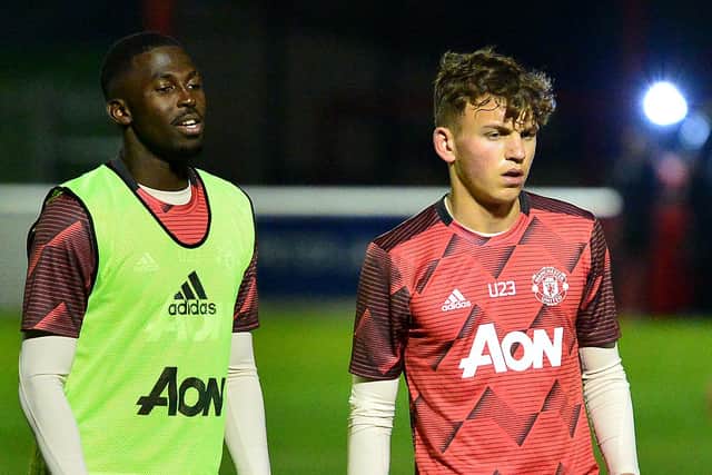 Aliou Traore (left) and Dion McGhee pictured before a Manchester United Under-23 game in January. The duo are on Celtic and Rangers' radars respectively