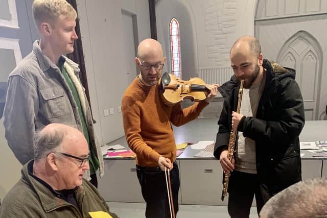 Jay Capperauld, violinist Gordon Bragg and flautist André Cebrián (all standing) with participants at a Seen and Heard session at Craigmillar Now PIC: SCO