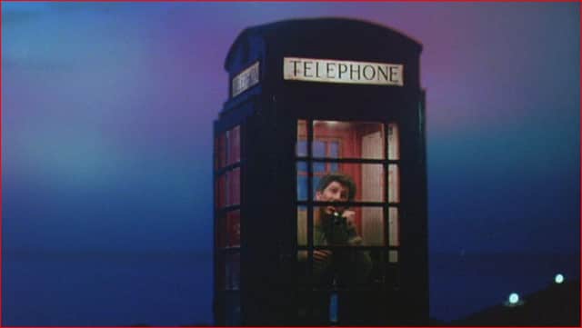 Peter Riegert as Mac inside the film's famous phone box that connected the fictional village of Ferness to the world. PIC: Contributed.