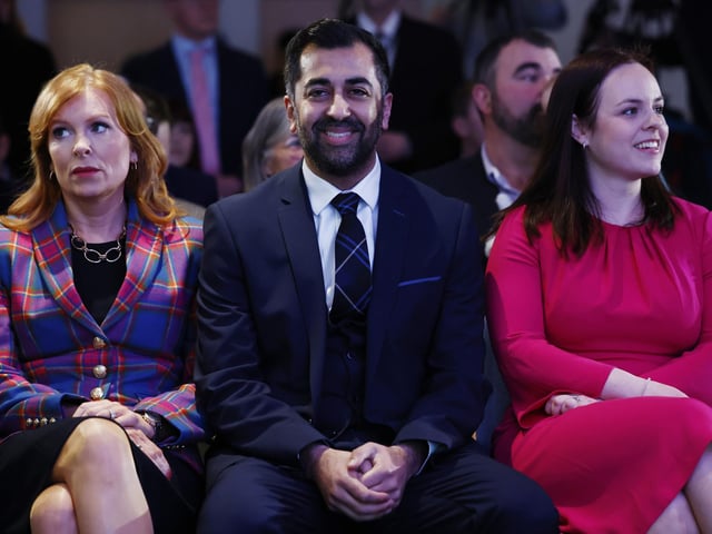 Humza Yousaf (C) reacts as the SNP vote for their new party leader