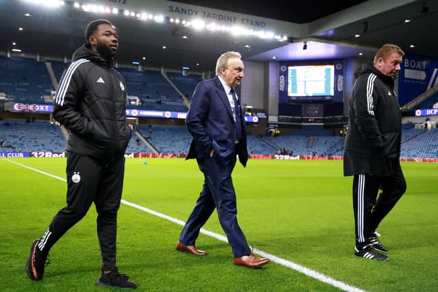 Neil Warnock, centre, was suited and booted prior the match between Rangers and Aberdeen at Ibrox.