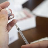 A pharmacist prepares to fill a syringe with Pfizer-BioNTech Covid-19 vaccine. Picture: AP Photo/Rogelio V. Solis