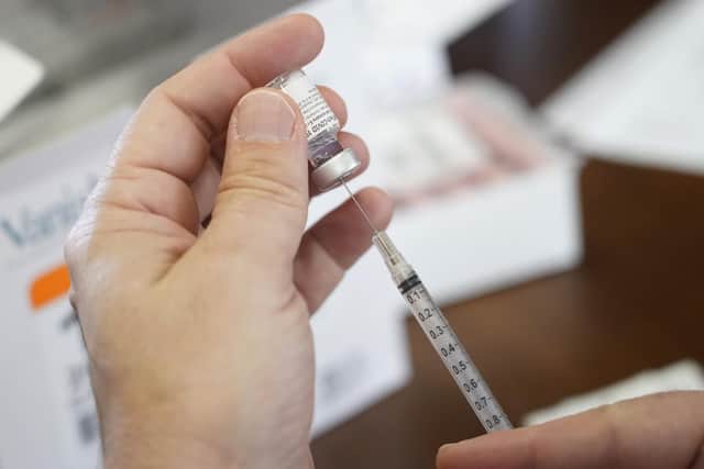 A pharmacist prepares to fill a syringe with Pfizer-BioNTech Covid-19 vaccine. Picture: AP Photo/Rogelio V. Solis