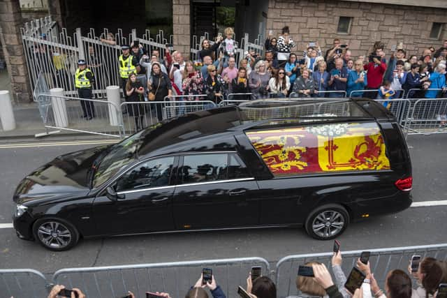 The hearse carrying the coffin of Queen Elizabeth II travels along the Royal Mile in Edinburgh to the Palace of Holyroodhouse as it completes it journey from Balmoral. Picture date: Sunday September 11, 2022.