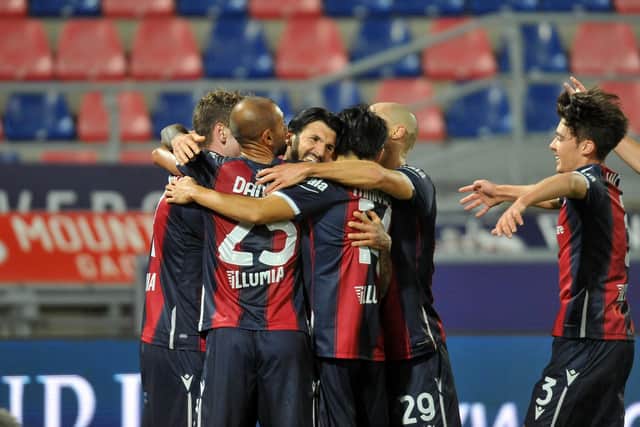 Debutant Aaron Hickey, right, joins in the celebrations after Roberto Soriano had opened the scoring for Bologna.