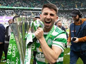Celtic's Greg Taylor celebrates with the Premiership trophy after last weekend's 6-0 win over Motherwell on the final day of the season.  (Photo by Craig Williamson / SNS Group)
