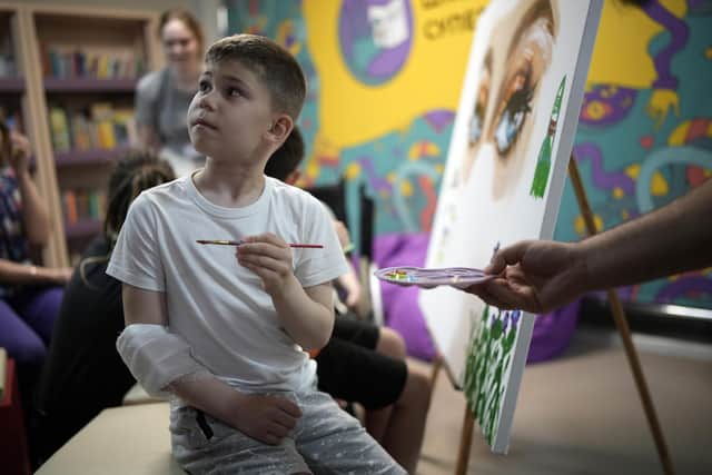 An injured boy from the southern Ukrainian city of Mariupol takes part in an arts therapy session in Kyiv last year. Picture: Getty Images
